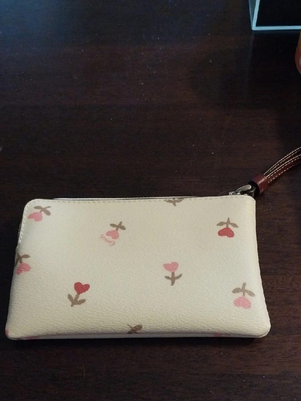 Coach Cream Wristlet with Pink Floral Accents and Brown Strap